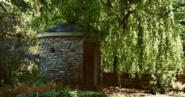 Hideaway - A small stone building surrounded by trees and bushes